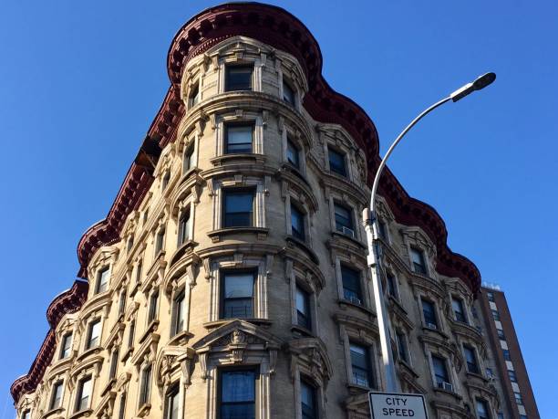 Corner of an old Harlem building against a blue sky