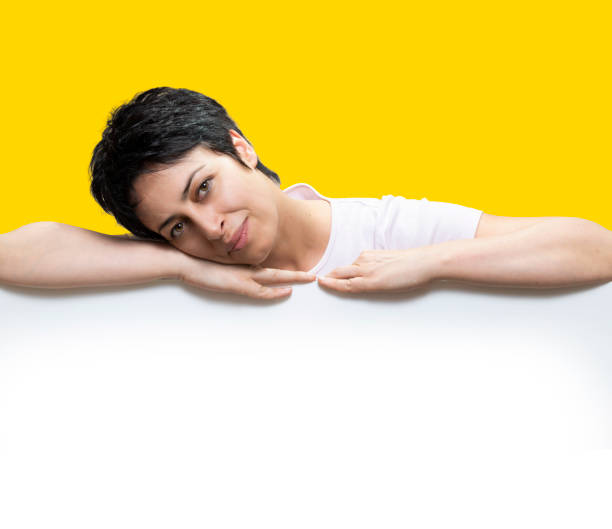 istock A Woman pointing down at blank space 1474208046