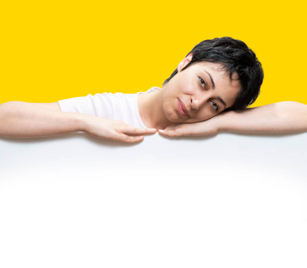 istock A Woman pointing down at blank space 1474208082