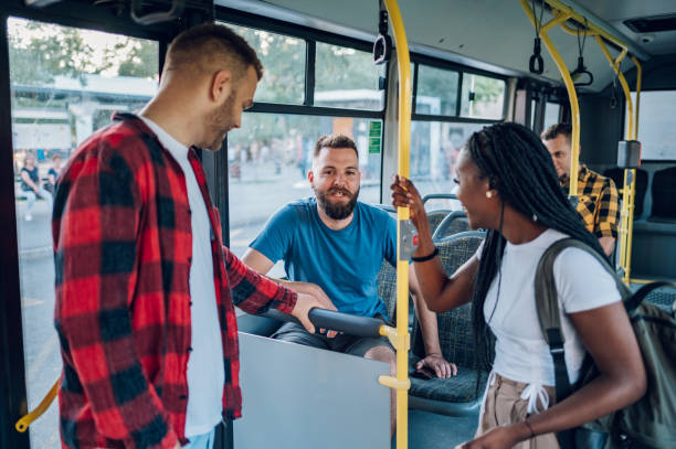 istock Multiracial friends talking while riding a bus in the city 1474209439