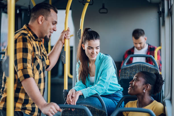 istock Multiracial friends talking while riding a bus in the city 1474209448