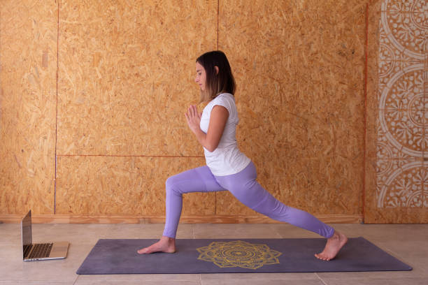 istock Young woman standing with hands in anjali mudra position 1474210734