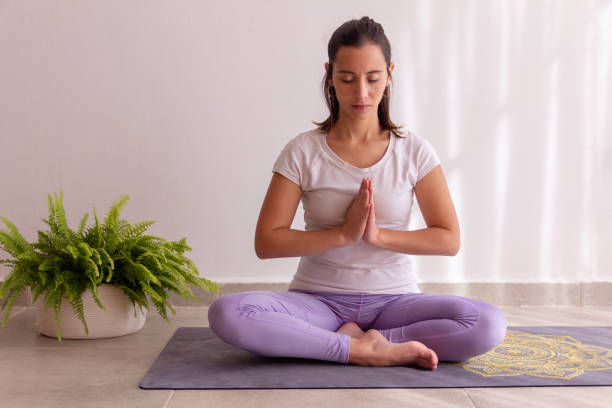 istock Young beautiful woman meditating at home 1474210754