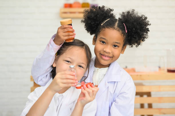 istock Child in classroom at school, Kid dressed science lab coat, Science concept 1474210851