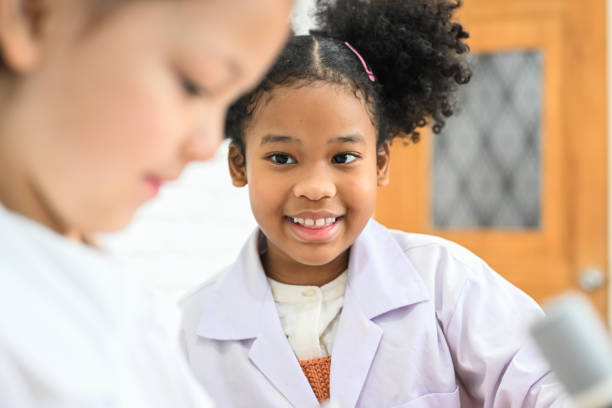 istock Child in classroom at school, Kid dressed science lab coat, Science concept 1474211007