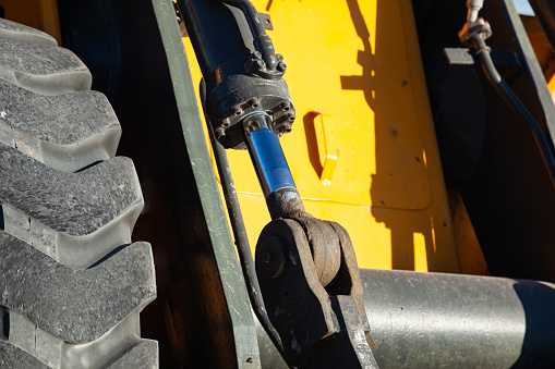 Frontal bulldozer loader. Yellow excavator close up.