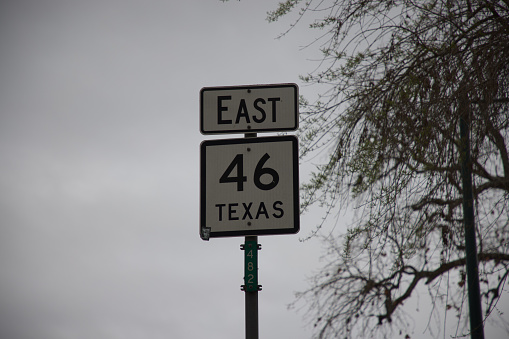 A close view of the black and white mile marker sign.