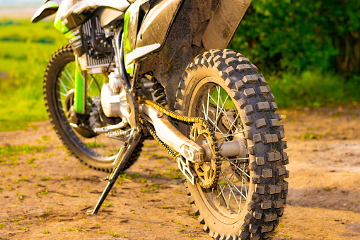 extreme cross enduro motorcycle is off-road. the rear wheel is in focus. part of a motorcycle. selective focus