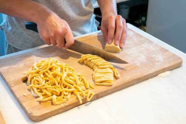 istock Woman's hand cutting natural homemade pasta 1474216319