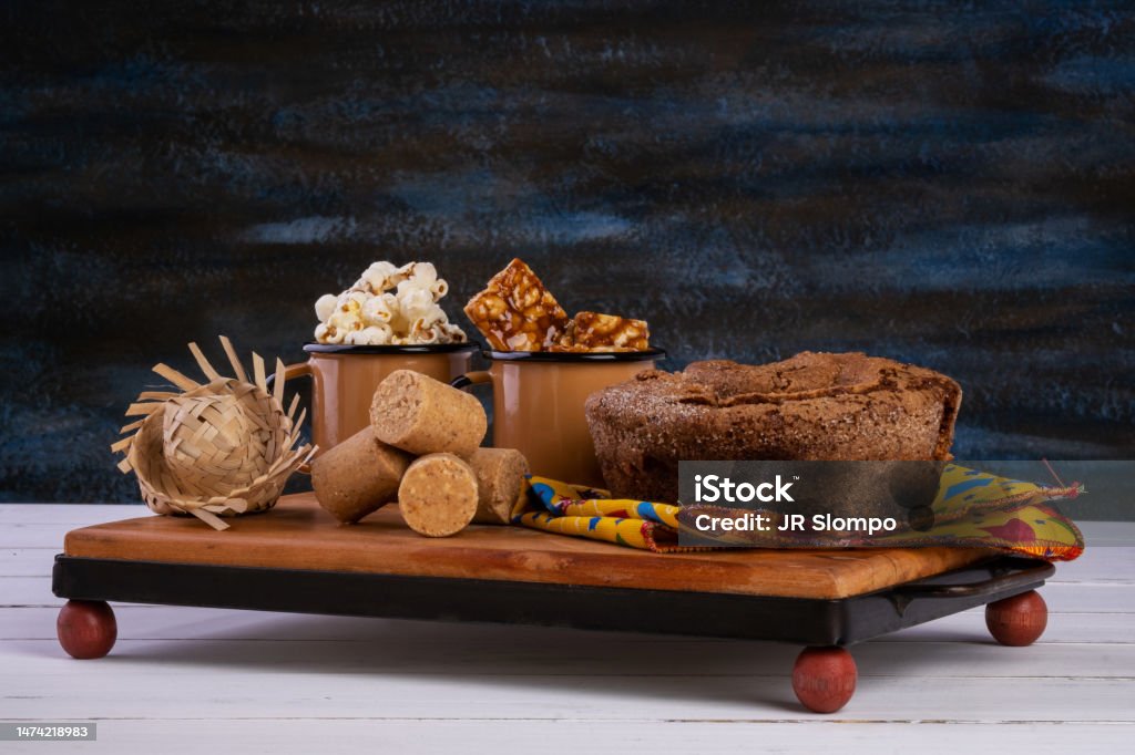 wooden tray with cake, popcorn and sweets from festa junina wooden tray with cake, popcorn and sweets from festa junina. Festa Junina Stock Photo