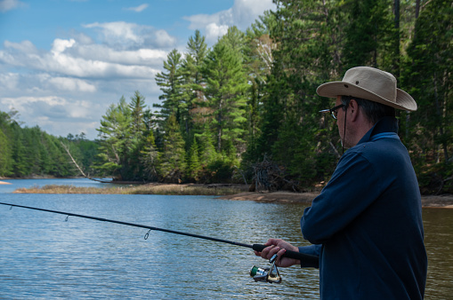 Fisherman fishing in a lake in the mountains