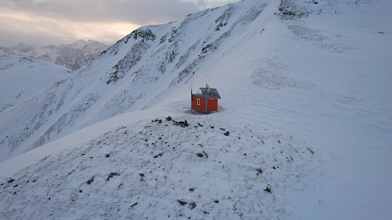 Rescue hut high in the mountains among the clouds