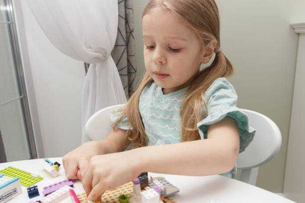 istock Child builds with constructor bricks, plays with toys 1474220460