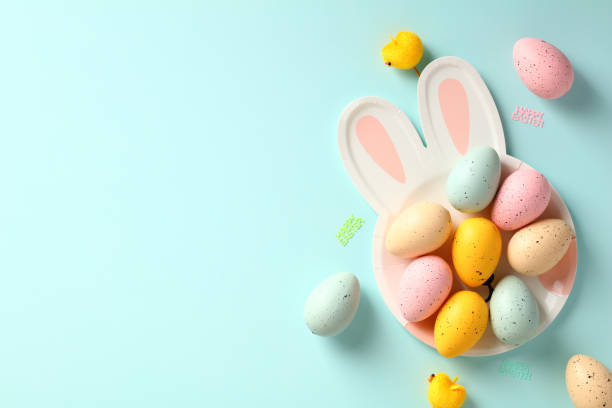 istock Easter rabbit shaped plate with colorful Easter eggs on blue background. Happy Easter greeting card template. 1474222434
