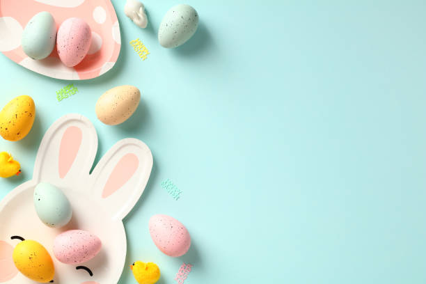 istock Happy Easter greeting card template. Easter table with colorful eggs and plates on blue background. 1474222522