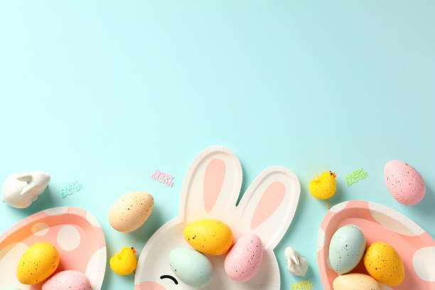 istock Happy Easter greeting card template. Frame border made of Easter eggs, plates, decoration on blue background. 1474222568