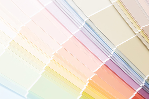 Close-up on a customer holding a color sample at a home improvement store - remodeling and painting concepts