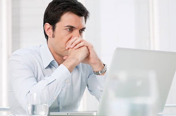 istock Pensive man at laptop 147422326