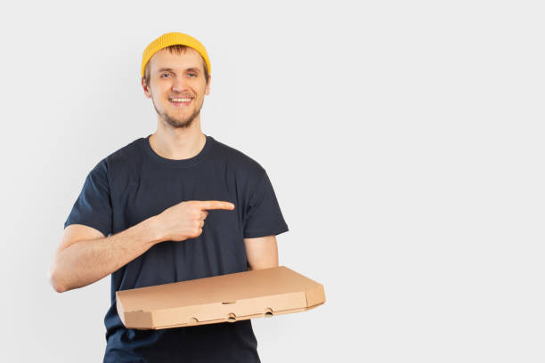 istock Young man with pizza box in his hands, pizza delivery 1474227364
