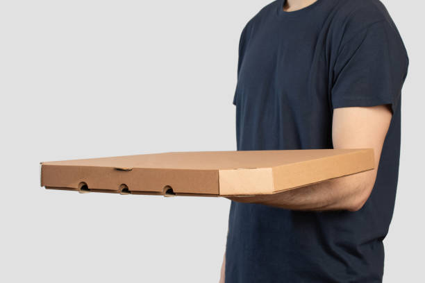 istock Young man with pizza box in his hands, pizza delivery 1474227376