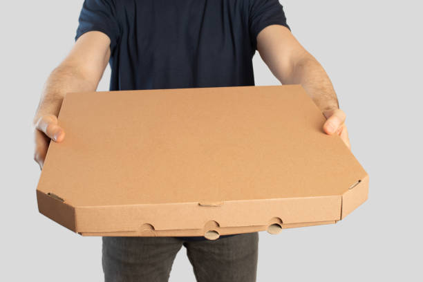 istock Young man with pizza box in his hands, pizza delivery 1474227412