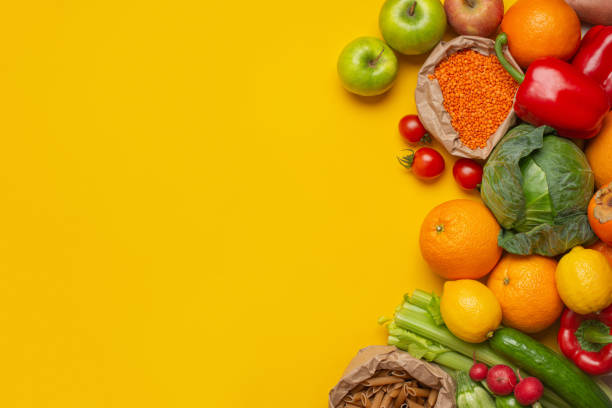 istock bright vegetables and fruits on a yellow background 1474227587