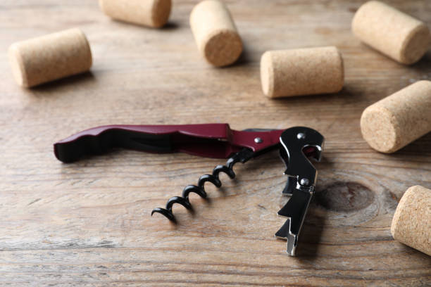 istock Opener with corkscrew and corks on wooden table 1474228579