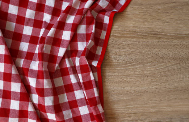 istock Checkered picnic cloth on wooden table, top view. Space for text 1474229742