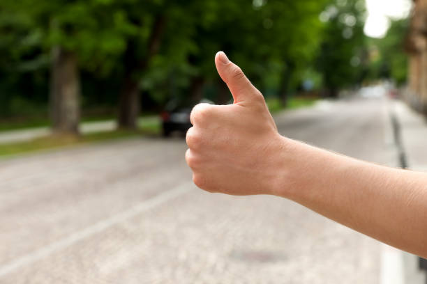 Man catching car on road, closeup and space for text. Hitchhiking trip Man catching car on road, closeup and space for text. Hitchhiking trip hitchhiking stock pictures, royalty-free photos & images