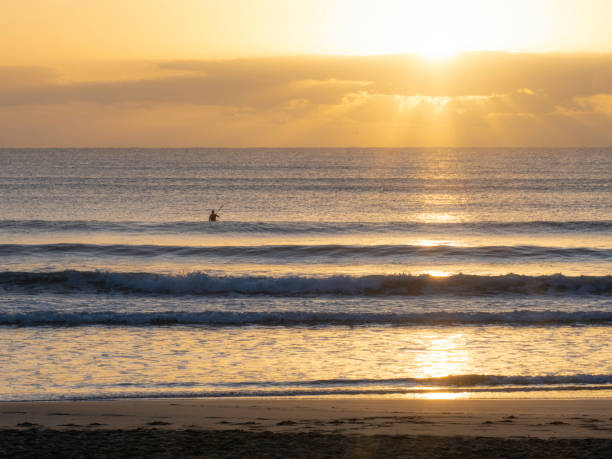 istock Sunrise kayaker at beach in silhouette 1474232682