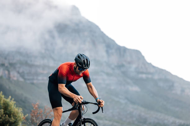 istock Professional rider on a bike doing intense training outdoors against the mountain with clouds 1474237003