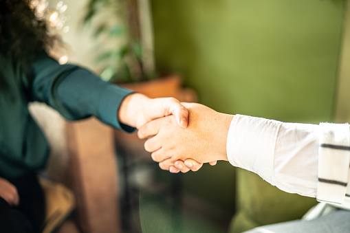 Close-up of handshake indoors