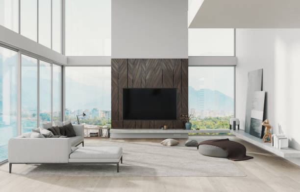 A contemporary living room featuring a flat-screen TV mounted on a wooden-paneled wall with decorative vases and a sleek entertainment console.