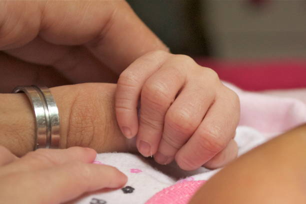 istock Newborn baby hand grasping a finger 1474240564