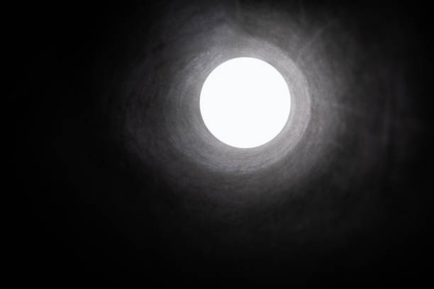 A black tunnel with a bright white light at the end.