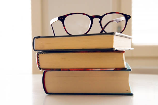 istock stack of books witht eyeglasses on top of them 1474242440