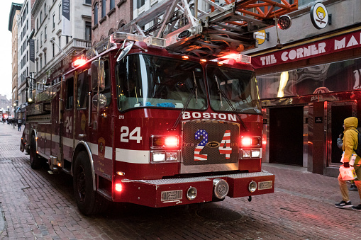 Boston, USA - Mar 7th, 2023: Boston fire deparment responding to an emergency downtown late in the day.