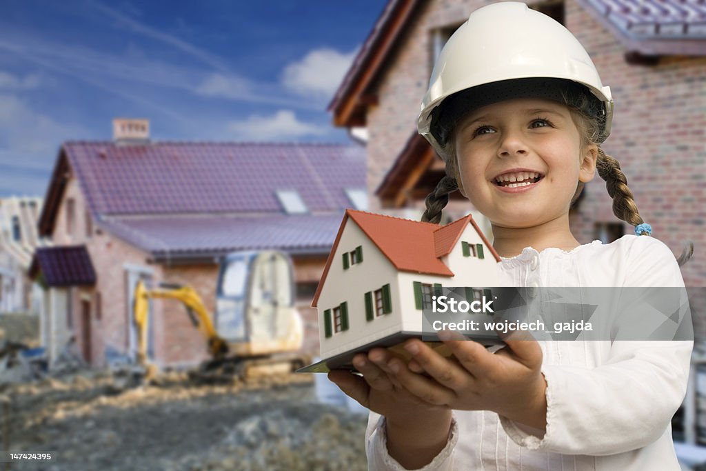 Family house concept Family house concept - Outdoor portrait of little constructor girl with house model Architecture Stock Photo