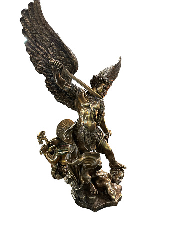 St.  Michael standing over demon statue isolated on white background