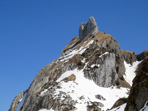 Rocky peak Dejenstogg or Dejenstock (2022 m) in the Glarus Alps mountain range, over the Klöntalersee (or Kloentalersee) reservoir lake and Klöntal alpine valley - Canton of Glarus, Switzerland (Schweiz)