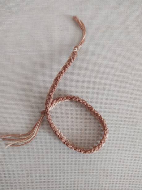 istock Hand-made anklet shot on a beige surface 1474249119