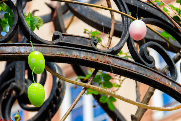 istock Colorful painted decorative Easter eggs hanging by an iron frame outside 1474250631