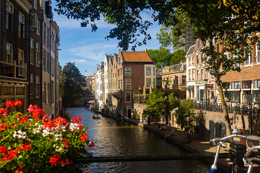 Cityscape of Utrecht, view of city canal embankment with typical butch houses along waterway.