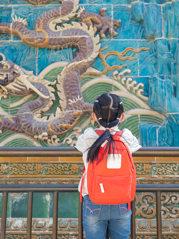 Little Asian Girl Visits Nine Dragon Screen in Beihai Park in Beijing