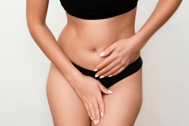 Woman holding her crotch with her hands, suffering from itching, pain, cystitis A young woman in black underwear holding her crotch with her hands, suffering from itching, pain, cystitis women private part pic stock pictures, royalty-free photos & images