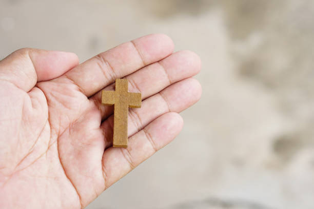 istock cross representing Jesus in human hand 1474259902