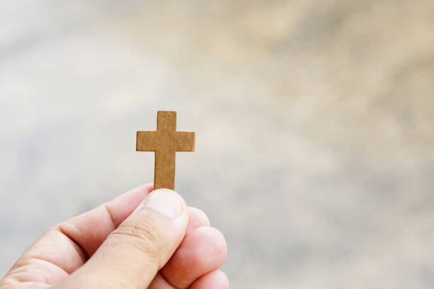istock cross representing Jesus in human hand 1474259988