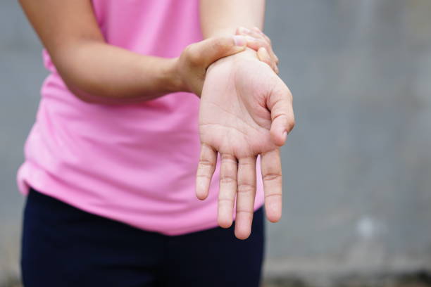 istock Woman holding her wrist pain from using computer, office syndrome 1474260292