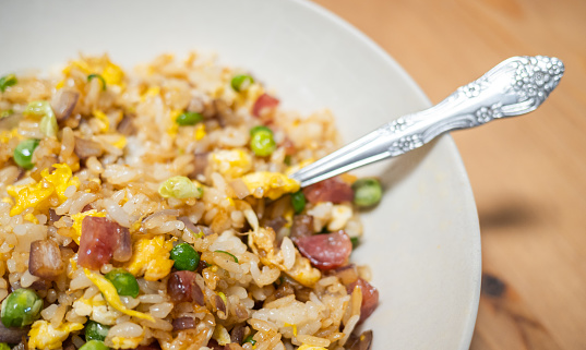 Caribbean coconut rice with red kidney beans, cowpeas and pigeon peas. Scotch bonnet chilies and lime on side.