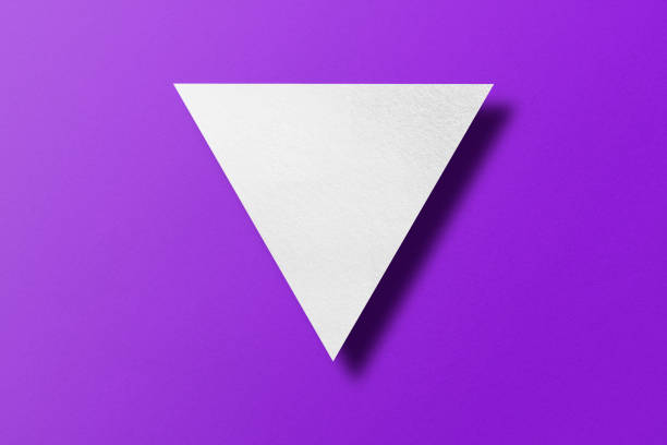 istock White paper cut into triangle shape, play button set on purple paper background. 1474261835